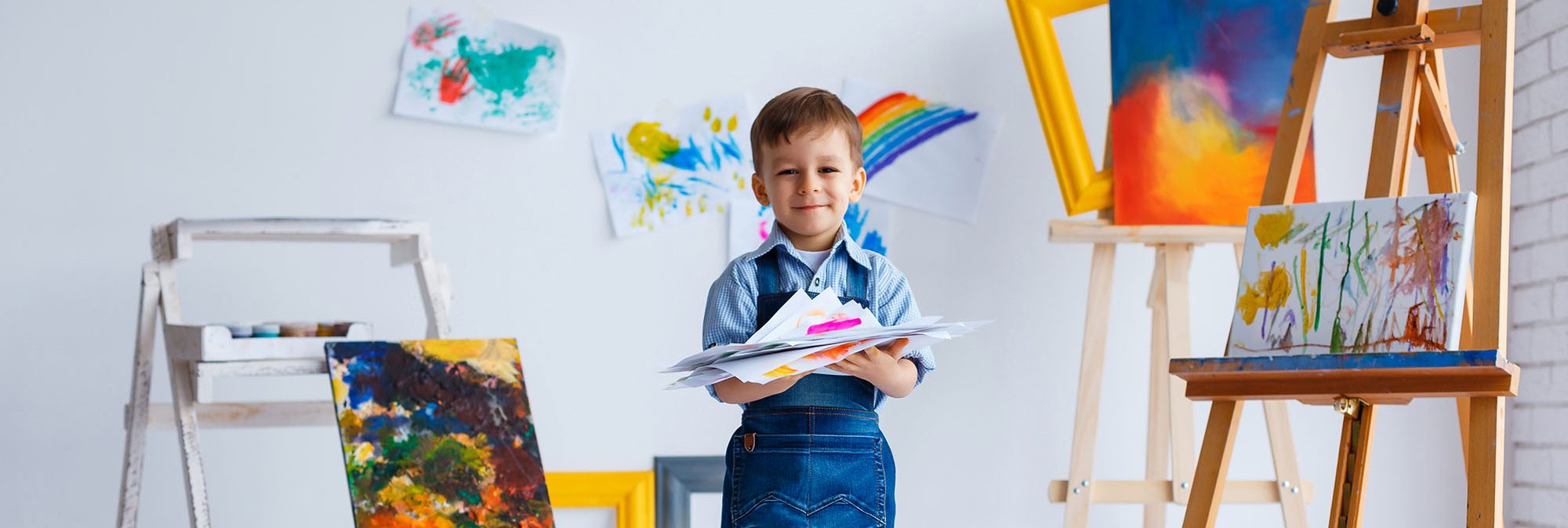 picture of a young child painting at an easel