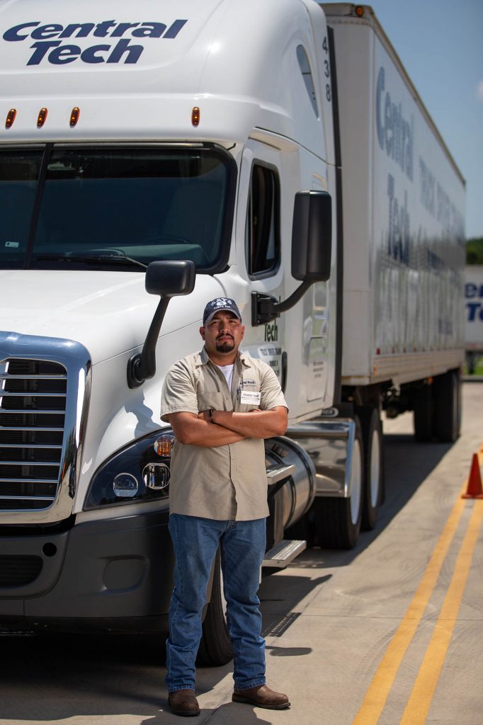picture of a man with his CDL license by a Central Tech semi truck
