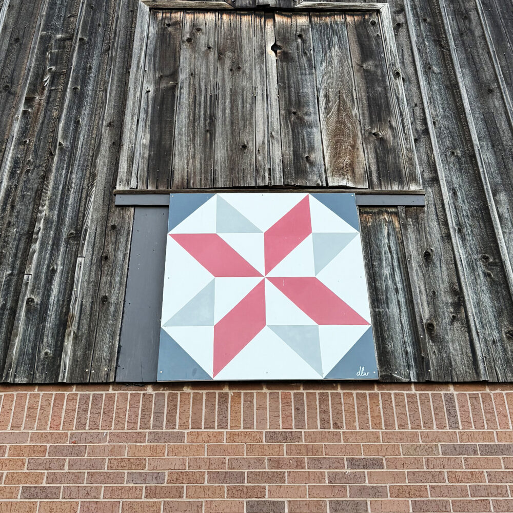 barn-quilt-painting-on-wood-hanging-on-barn