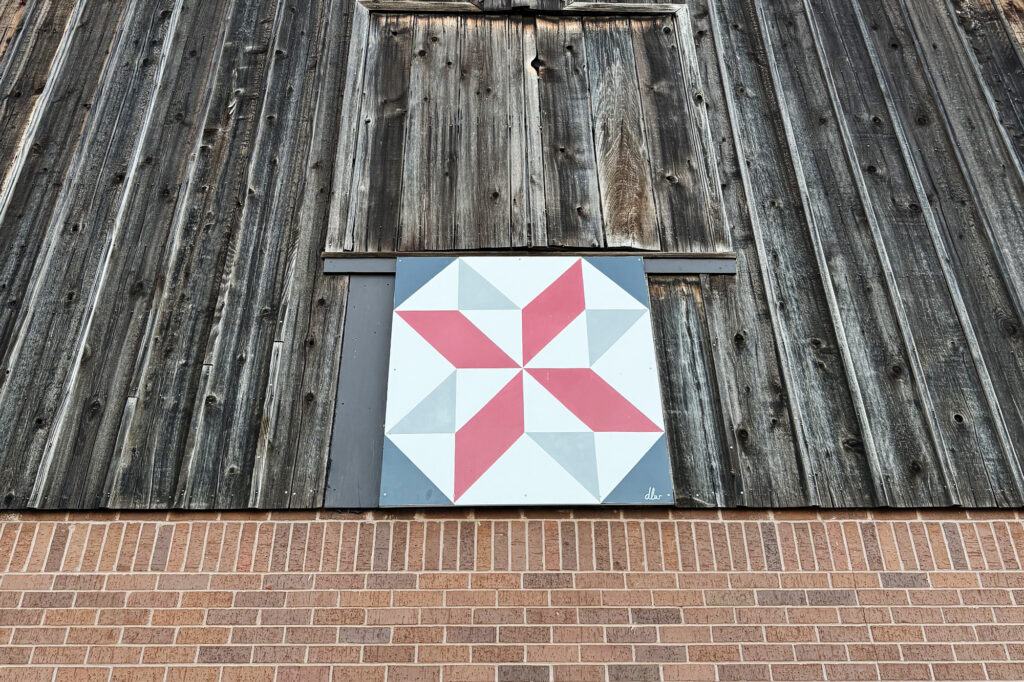 barn-quilt-painting-on-wood-hanging-on-barn