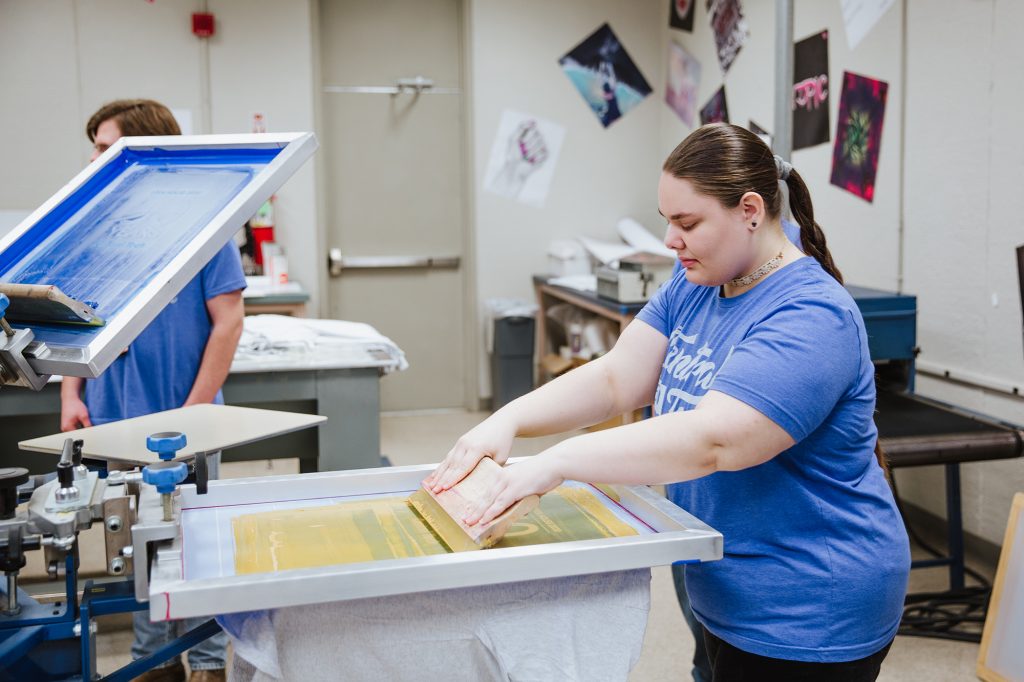 DPIC student printing a shirt