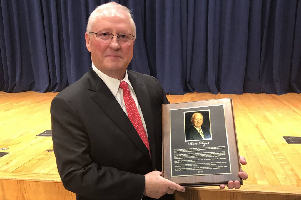 Ron Dyer holding his Drumright Hall Of Fame award