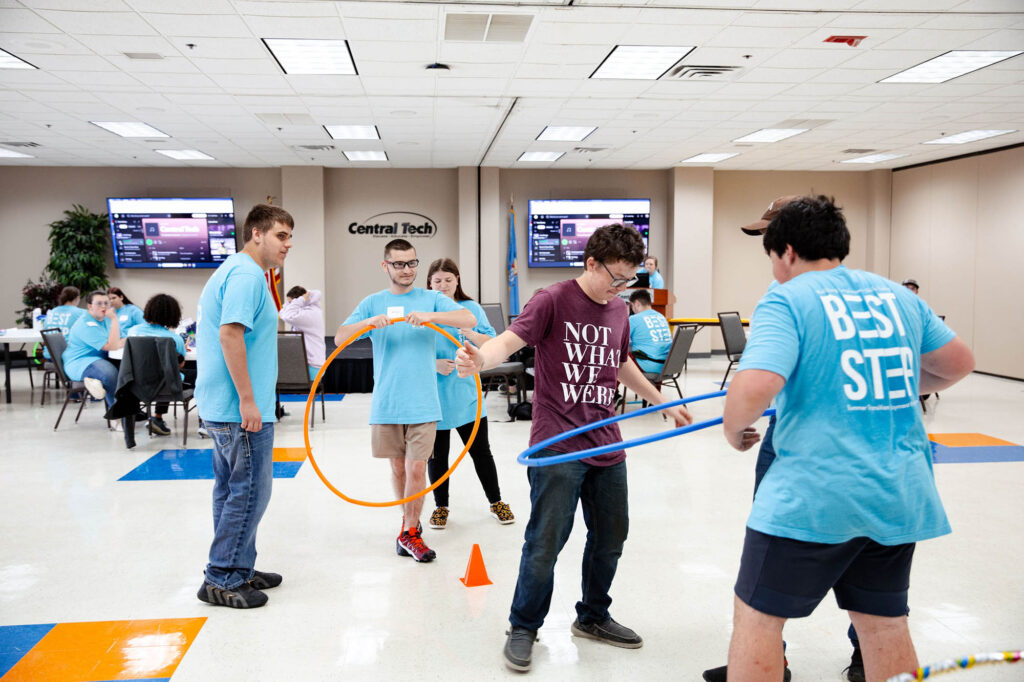 campers-test-their-teamwork-skills-getting-hula-hoop-over-cone-without-using-their-hands Campers test their teamwork skills by getting a hula hoop over a cone without using their hands.