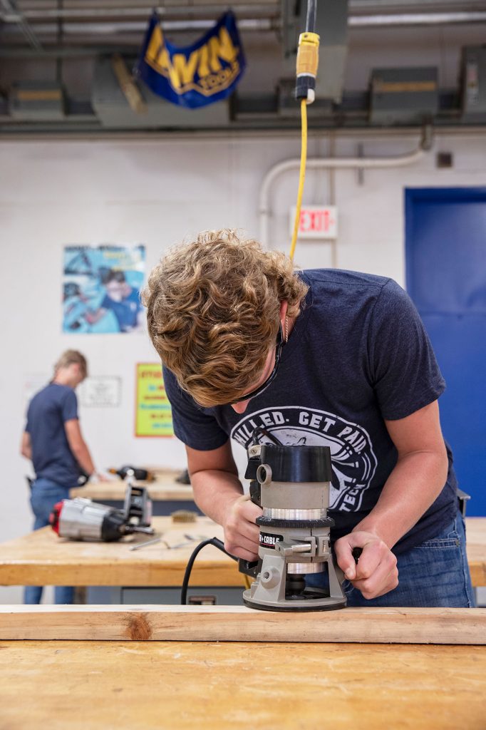 construction student using a router at Central Tech Drumright