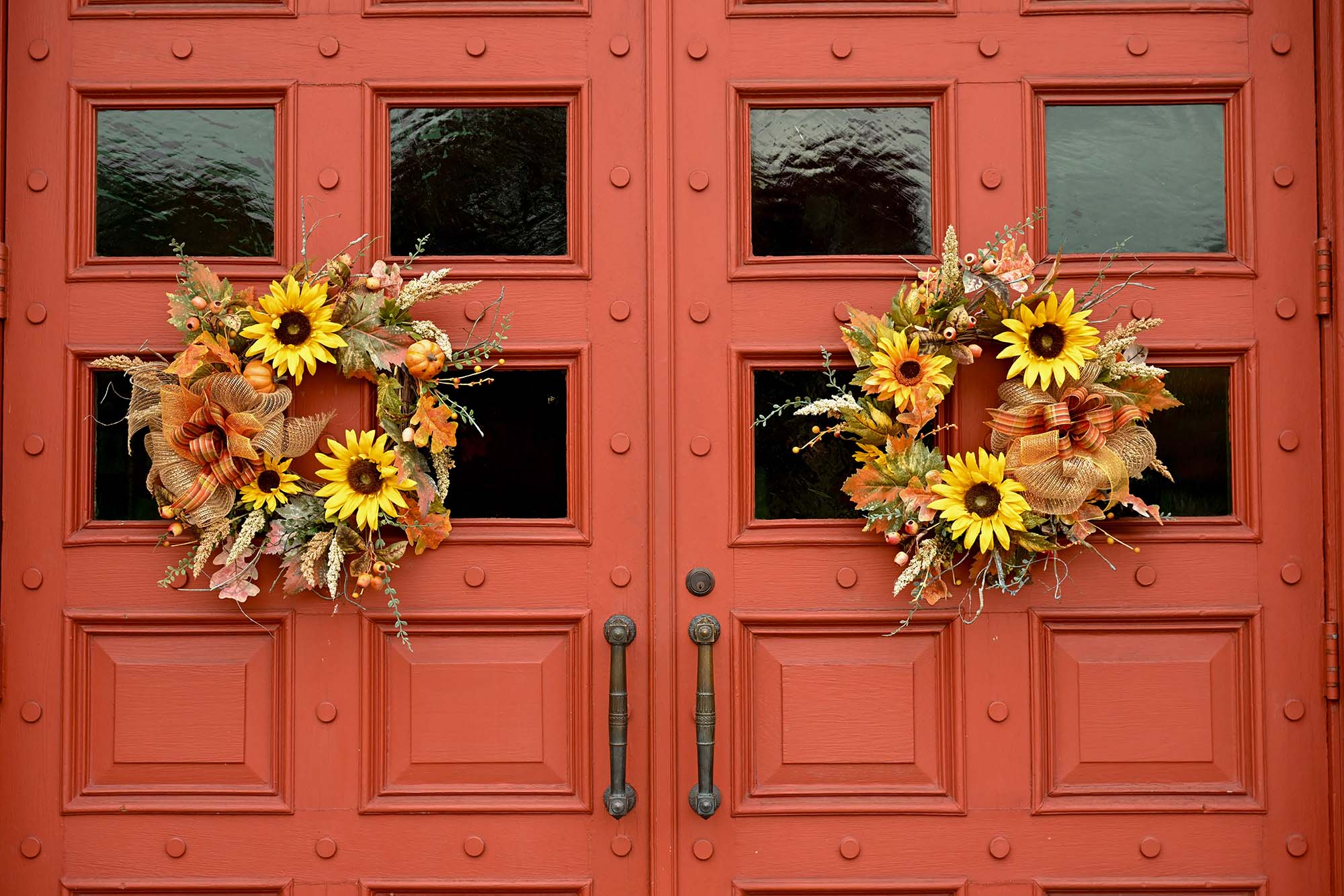 fall wreath on old red doors