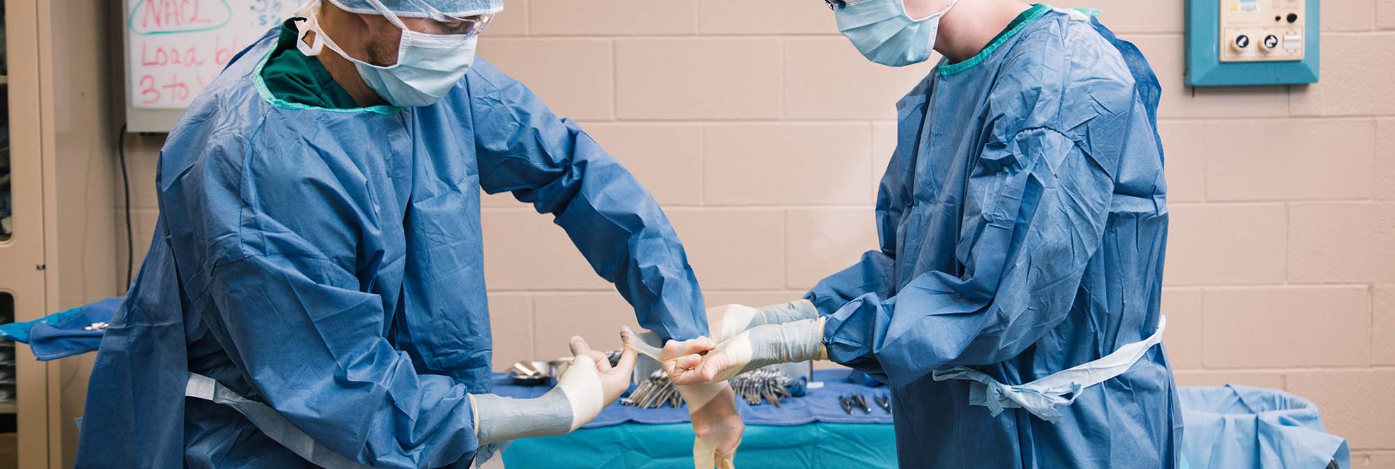 surgical technologist students at Central Tech gloving up