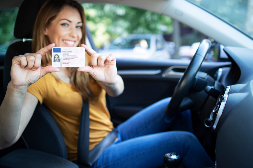 woman holding drivers license woman holding drivers license
